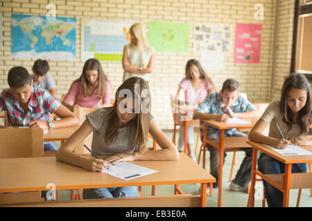 Students taking test in classroom Stock Photo