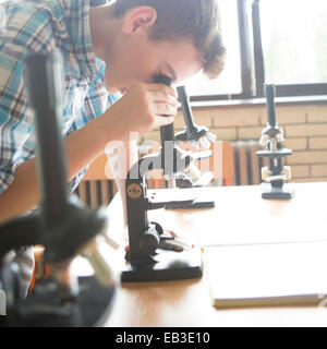 Student using microscopes in science class Stock Photo