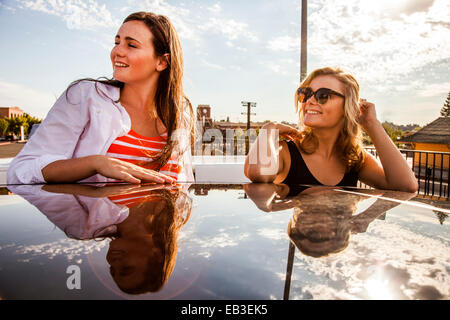 Caucasian teenage girls reflected in car roof Stock Photo