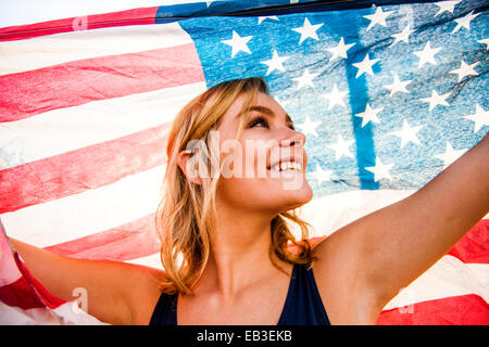 Caucasian teenage girl holding American flag