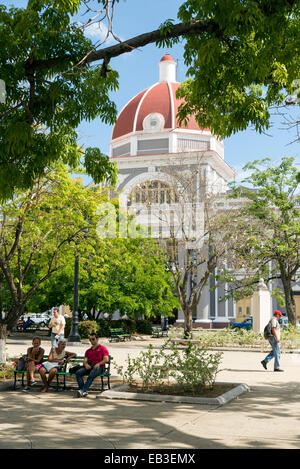 CIENFUEGOS, CUBA - MAY 7, 2014: Town hall of Cienfuegos city at Jose Marti park with some locals in Cienfuegos, Cuba Stock Photo