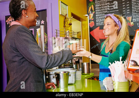 Woman serving customer smoothie in cafe Stock Photo