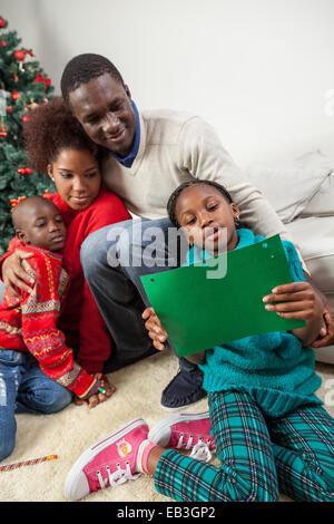 Girl reading the letter that wrote to Santa Stock Photo