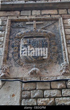 Carved stone seal of the Tribunal of the Holy Office of the Inquisition (Spanish Inquisition) decorates the exterior of the bui Stock Photo