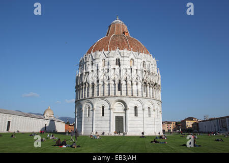 PISA, ITALY - MARCH 7, 2014: people in the famous Miracles square under the Saint John Baptistery Stock Photo