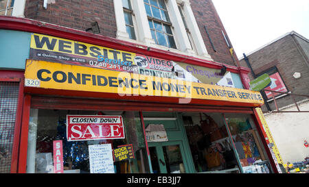Confidence Money Transfer Service shop closing down sale sign on Tottenham High Rd in Seven Sisters London N15 UK  KATHY DEWITT Stock Photo
