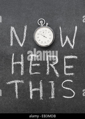 now here this concept handwritten on chalkboard with vintage precise stopwatch used instead of O Stock Photo