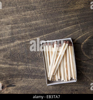 safety matches on wooden table, from above Stock Photo