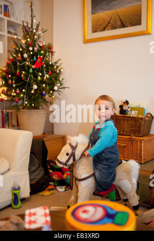 Toddler on rocking horse Stock Photo