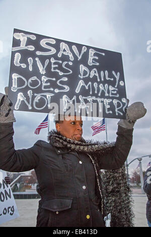 Detroit, Michigan, USA. 25th Nov, 2014.  An African-American nurse joins a protest over decision of a grand jury in Ferguson, Missouri not to indict a white police officer for the killing of Michael Brown, an unarmed African-American teenager. Credit:  Jim West/Alamy Live News Stock Photo
