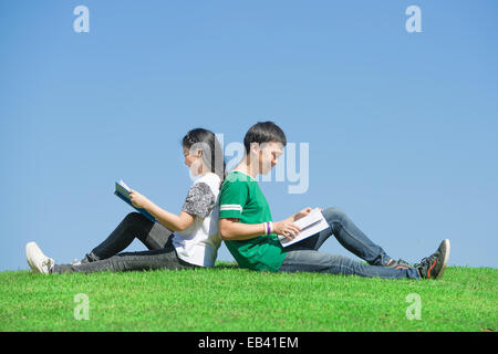 Couple of Asian students outdoors looking very happy Stock Photo