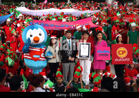 Bangkok. Thailand. 25th Nov, 2014. Richard Stenning the representative of Guinness World Records Certification Ceremony to Narathip Rattapradit management of Siam Paragon the world record with the sort of people dressed as Santa's Elves in the world. Total of 1,762 of Thai people dressed up as Santa's Elves gather in an attempt to break the current Guinness World Records made by 1,100 Santa's Elves in England. Stock Photo