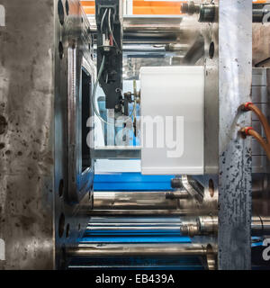 Plastic Injection molding machine working in factory Stock Photo