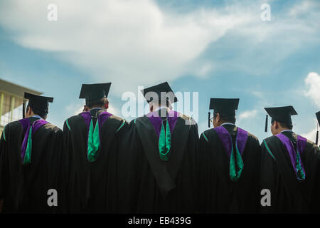 Back of graduates with blue sky Stock Photo