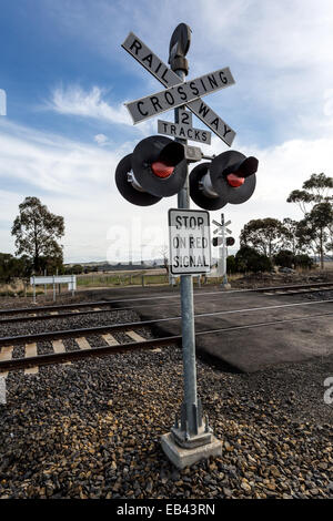 Railway crossing and signal lights on country road near Melbourne, Australia Stock Photo