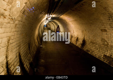 The Greenwich Foot Tunnel crosses beneath the River Thames in East London, linking Greenwich (Royal Borough of Greenwich) in the Stock Photo