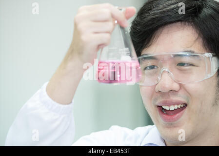 Asian researcher carrying out experiments in a laboratory - looking surprised Stock Photo