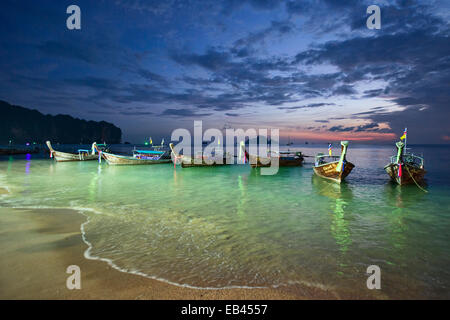 longtail boats in the bay at sunset, Ao Nang, Thailand Stock Photo