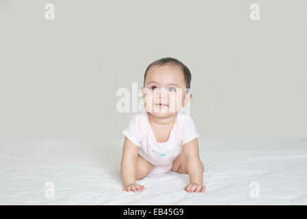 Asian cute girl baby crawling in bedroom Stock Photo