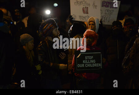 Ferguson, USA. 25th Nov, 2014. Demonstrators attend a protest outside Ferguson police station, St. Louis County, Missouri, the United States of America, Nov. 25, 2014. More than 1,500 National Guard troops joined about 700 guardsmen who were already on the scene to help local law enforcement protect residents and property in Ferguson, one day after a grand jury declined to hand up an indictment against Ferguson police officer Darren Wilson, who shot and killed unarmed teenager Michael Brown in August. Credit:  Yin Bogu/Xinhua/Alamy Live News Stock Photo