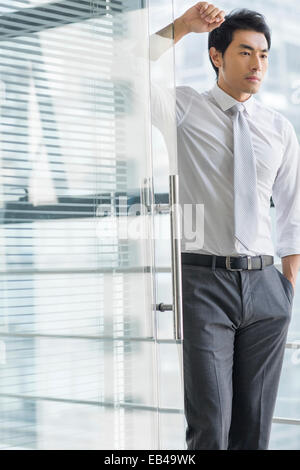 Young businessman thinking in office Stock Photo