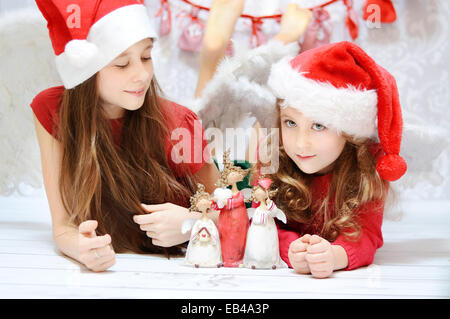 Two cute girls enjoying the Christmas Stock Photo