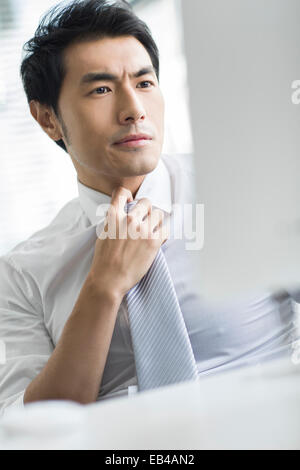 Displeased young businessman in office Stock Photo