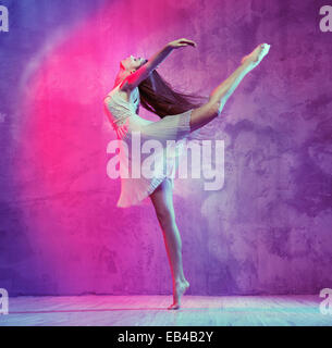 Flexible pretty ballet dancer on the dance floor Stock Photo