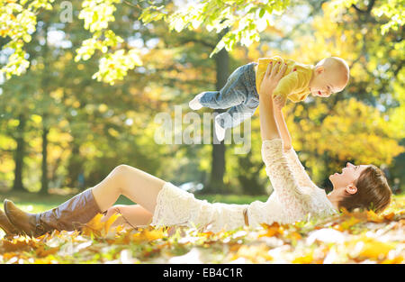 Young woman making her baby laughing Stock Photo