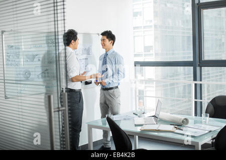 Young businessmen talking in office Stock Photo