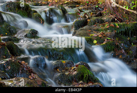 Beautiful cascading waterfall over natural rocks Stock Photo