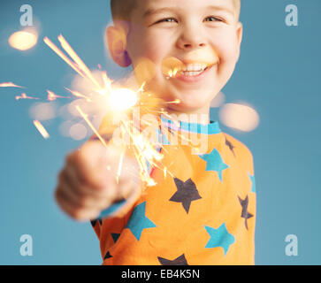 Little man holding a sparkler Stock Photo