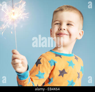 Delighted kid watching a sparkler Stock Photo