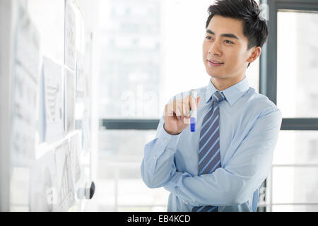 Young businessman thinking in office Stock Photo