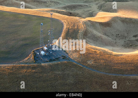 Communication towers in an arid, hilly landscape outside of Kennewick, Washington. Stock Photo