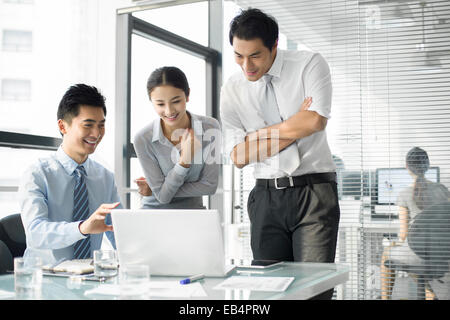 Young business people using laptop in office Stock Photo
