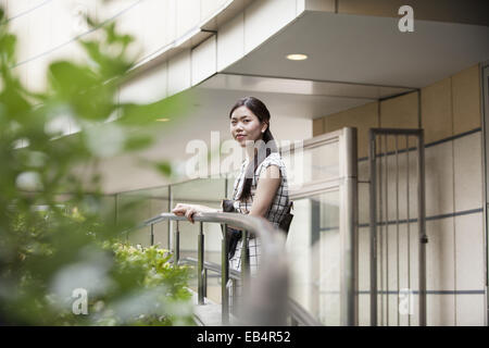 A woman on a walkway in Namba Park office and shopping complex. Stock Photo