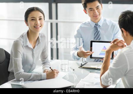 Young business people using digital tablet in office Stock Photo