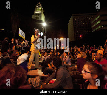 Los Angeles, California, USA. 25th Nov, 2014. A man uses a megaphone to share his thoughts on the Ferguson Verdict to several dozen protesters sitting in the street in front of the LAPD Headquarters on Tuesday evening. Los Angeles City Hall appears behind him in the photo. --- Tuesday night saw continued protests in Los Angeles as demonstrators rallied against the Ferguson Grand Jury and their decision not to indict officer Darren Wilson in the aftermath of his involvement in shooting Michael Brown in early August of this year. Credit:  David Bro/ZUMA Wire/Alamy Live News Stock Photo