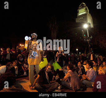 Los Angeles, California, USA. 25th Nov, 2014. A man uses a megaphone to share his thoughts on the Ferguson Verdict to several dozen protesters sitting in the street in front of the LAPD Headquarters on Tuesday evening. Los Angeles City Hall appears behind him in the photo.--- Tuesday night saw continued protests in Los Angeles as demonstrators rallied against the Ferguson Grand Jury and their decision not to indict officer Darren Wilson in the aftermath of his involvement in shooting Michael Brown in early August of this year. Credit:  David Bro/ZUMA Wire/Alamy Live News Stock Photo