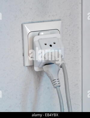 Multiple electrical plugs in wall outlet, Switzerland, Europe Stock Photo