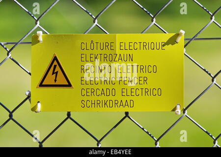 Danger high voltage sign on a fence Stock Photo