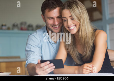 Cute couple using smartphone together Stock Photo
