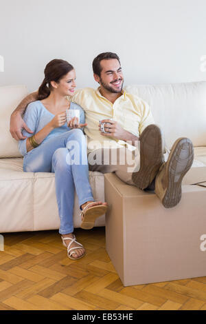 Young couple taking a break from unpacking Stock Photo
