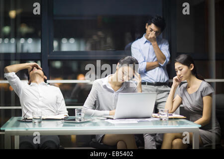 Tired business people having a meeting Stock Photo