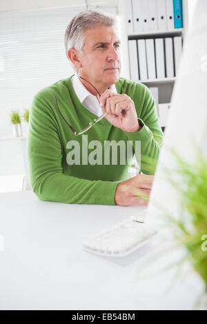 Casual businessman looking at computer screen Stock Photo