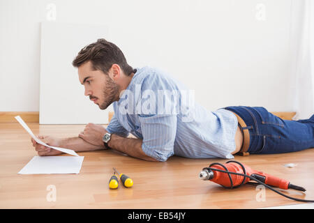 Casual man reading instruction manual for power tool Stock Photo