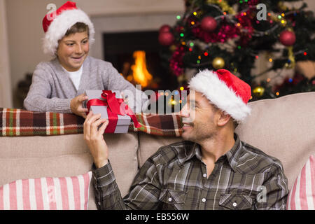 Father giving his son a christmas present Stock Photo