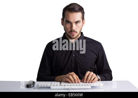 Serious businessman typing on keyboard Stock Photo