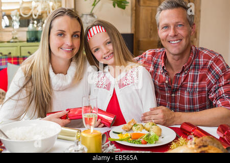 Portrait of parents and daughter together at christmas time Stock Photo